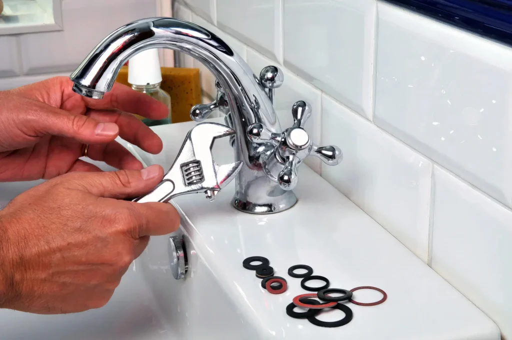 Plumber performing maintenance on a bathroom faucet in Imperial Beach