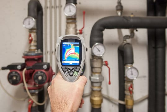 Plumber using a thermal imaging camera to inspect pipes in Imperial Beach