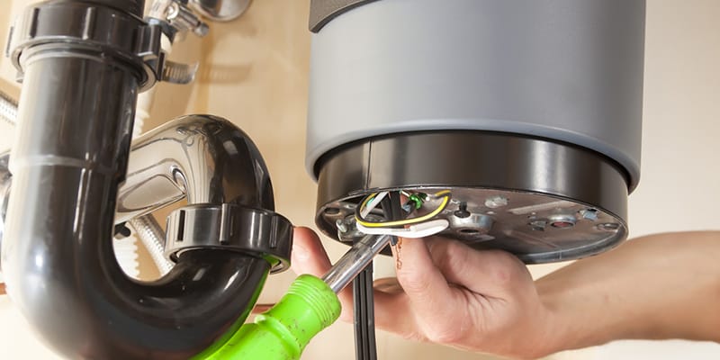 Technician repairing the heating element of a water heater in Imperial Beach