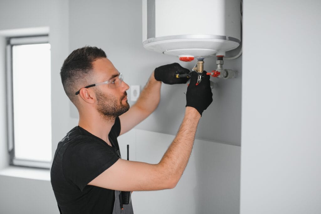 Technician performing water heater maintenance in Imperial Beach