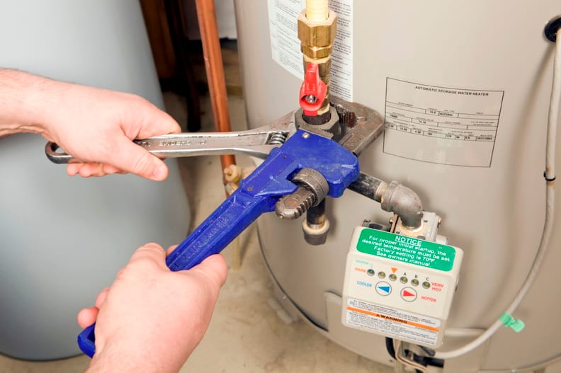 Plumber repairing a water heater valve in Imperial Beach